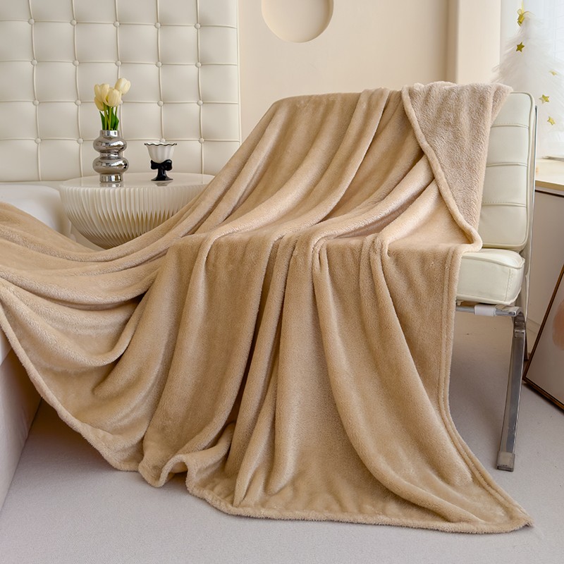 Camel-coloured blanket draped over a chair, from the product catalogue